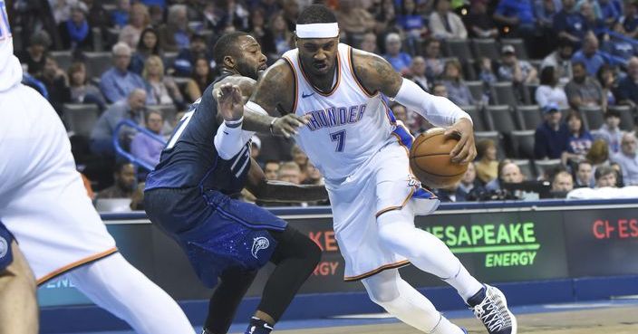 Oklahoma City Thundar's Carmelo Anthony, right, drives past Orlando Magic's Jonathan Simmons in the second half of an NBA basketball game in Oklahoma City, Monday, Feb. 26, 2018. (AP Photo/Kyle Phillips)