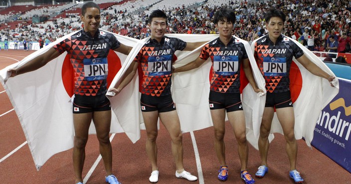 Japan's men's 4x100m relay team celebrate after winning the gold medal during the athletics competition at the 18th Asian Games in Jakarta, Indonesia, Thursday, Aug. 30, 2018. (AP Photo/Lee Jin-man)