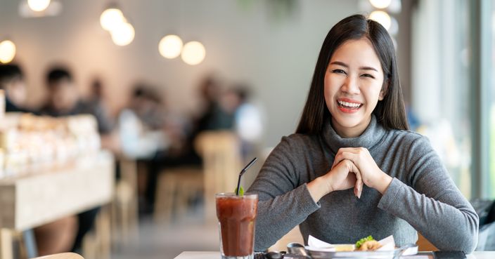 Portrait of young attractive asian woman looking at camera smiling with positive urban lifestyle concept at cafe background. Leisure relax time of young girl, asia student, teen or customer.