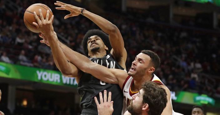 Brooklyn Nets' Jarrett Allen, left to right, Cleveland Cavaliers' Larry Nance Jr. and Brooklyn Nets' Joe Harris battle for a rebound in the second half of an NBA basketball game, Wednesday, Oct. 24, 2018, in Cleveland. The Nets won 102-86. (AP Photo/Tony Dejak)