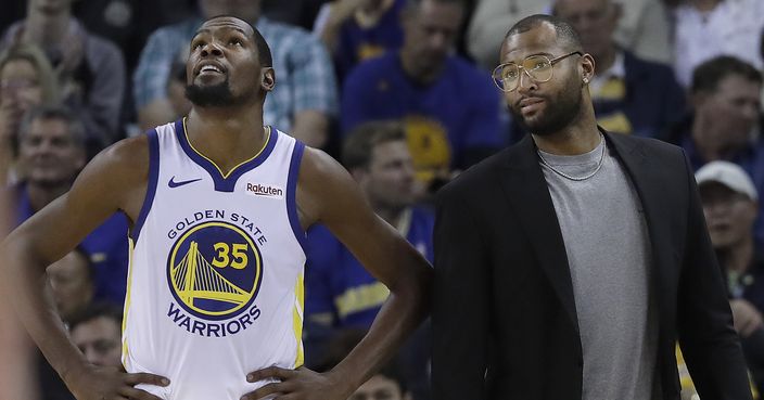 Golden State Warriors forward Kevin Durant (35) stands on the sideline with DeMarcus Cousins during the second half of an NBA basketball game against the Phoenix Suns in Oakland, Calif., Monday, Oct. 22, 2018. (AP Photo/Jeff Chiu)
