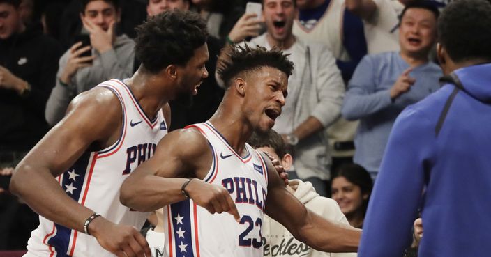 Philadelphia 76ers' Joel Embiid, left, congratulates teammate Jimmy Butler (23) after he sank a game-winning three point shot against the Brooklyn Nets in the fourth quarter of an NBA basketball game, Sunday, Nov. 25, 2018, in New York. The 76ers won 127-125. (AP Photo/Mark Lennihan)