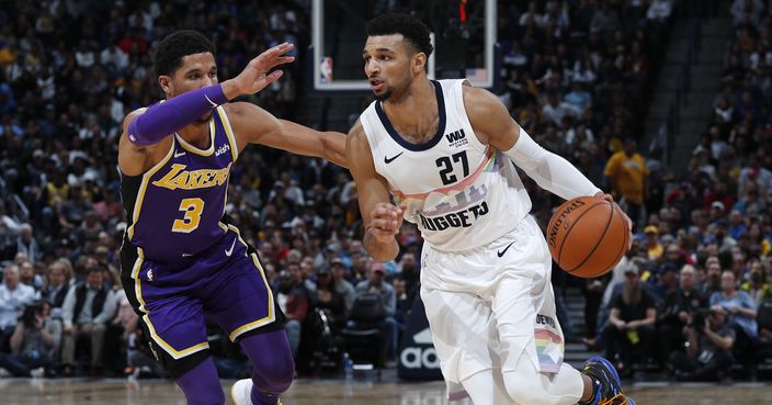 Denver Nuggets guard Jamal Murray, right drives past Los Angeles Lakers guard Josh Hart during the second half of an NBA basketball game Tuesday, Nov. 27, 2018, in Denver. The Nuggets won 117-85. (AP Photo/David Zalubowski)