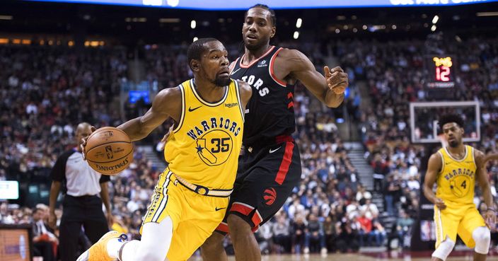 Golden State Warriors forward Kevin Durant (35) drives around Toronto Raptors forward Kawhi Leonard (2) during the second half of an NBA basketball game Thursday, Nov. 29, 2018, in Toronto. (Nathan Denette/The Canadian Press via AP)
