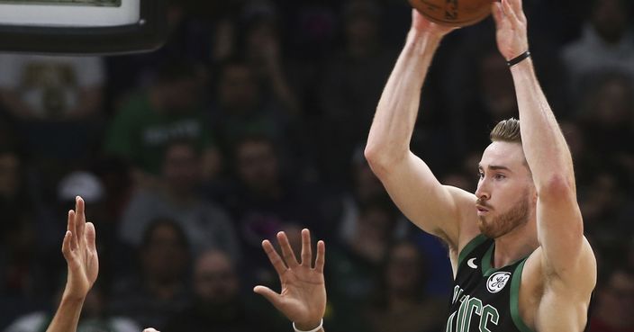 Boston Celtics' Gordon Hayward, right, looks to pass the ball over Minnesota Timberwolves' Karl-Anthony Towns, left, and Derrick Rose during the second half of an NBA basketball game Saturday, Dec. 1, 2018, in Minneapolis. (AP Photo/Jim Mone)