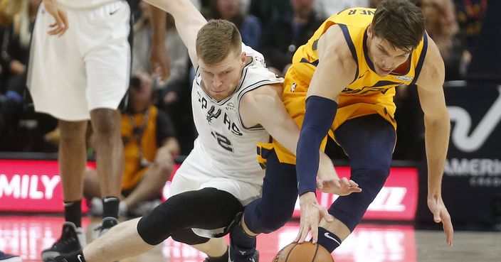 San Antonio Spurs forward Davis Bertans, left, and Utah Jazz guard Kyle Korver battle for a loose ball in the first half of an NBA basketball game, Tuesday, Dec. 4, 2018, in Salt Lake City. (AP Photo/Rick Bowmer)