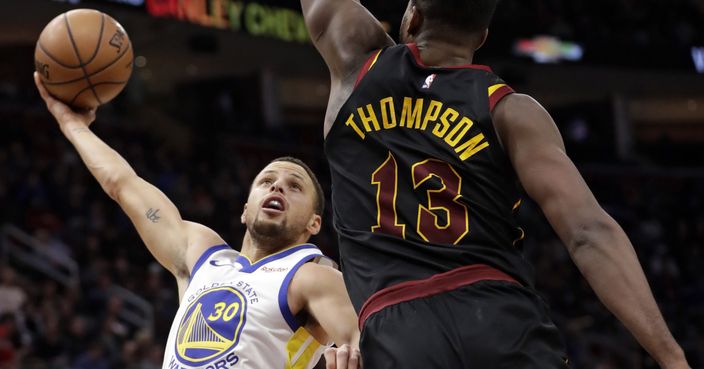 Golden State Warriors' Stephen Curry, left, drives to the basket against Cleveland Cavaliers' Tristan Thompson in the second half of an NBA basketball game, Wednesday, Dec. 5, 2018, in Cleveland. The Warriors won 129-105. (AP Photo/Tony Dejak)