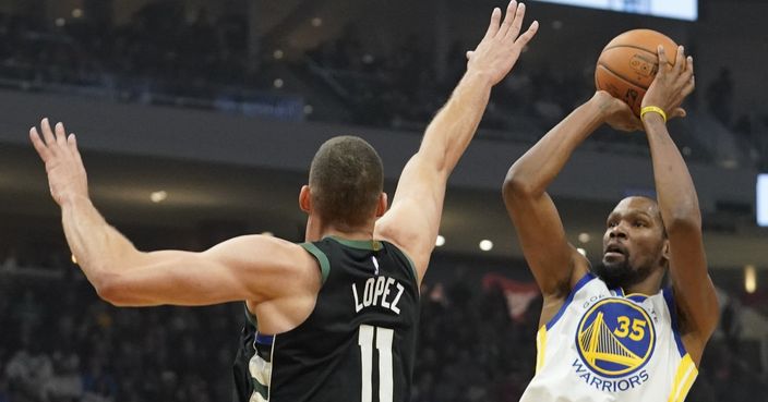 Golden State Warriors' Kevin Durant shoots over Milwaukee Bucks' Brook Lopez during the first half of an NBA basketball game Friday, Dec. 7, 2018, in Milwaukee. (AP Photo/Morry Gash)