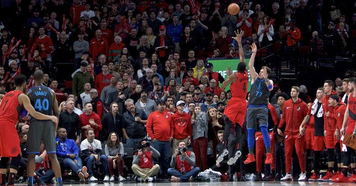 Dallas Mavericks forward Luka Doncic, right, makes a 3-point basket over Portland Trail Blazers forward Maurice Harkless with 0.6 seconds left to force overtime during the second half of an NBA basketball game in Portland, Ore., Sunday, Dec. 23, 2018. (AP Photo/Craig Mitchelldyer)