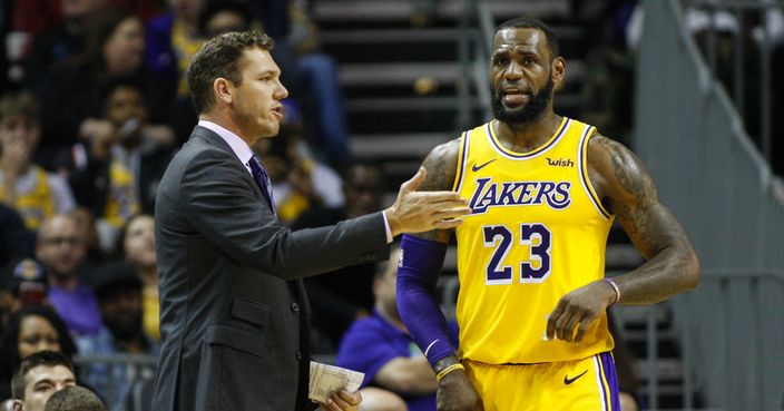 Los Angeles Lakers head coach Luke Walton, left, talks to orward LeBron James  in the second half of an NBA basketball game against the Charlotte Hornets in Charlotte, N.C., Saturday, Dec. 15, 2018. (AP Photo/Nell Redmond)