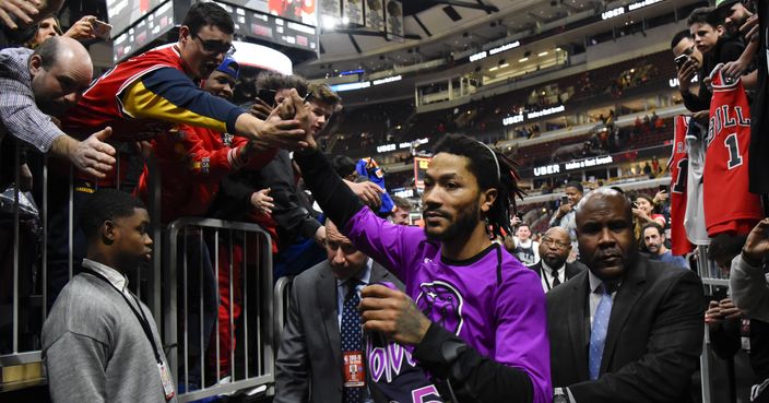 Minnesota Timberwolves guard Derrick Rose, center, greets fans after the team's NBA basketball game against the Chicago Bulls on Wednesday, Dec. 26, 2018, in Chicago. The Timberwolves won 119-94. (AP Photo/Matt Marton)