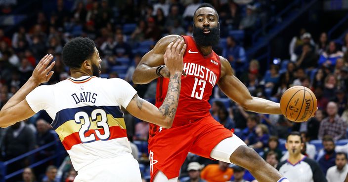 Houston Rockets guard James Harden (13) passes the ball around New Orleans Pelicans forward Anthony Davis (23) during the first half of an NBA basketball game, Saturday, Dec. 29, 2018, in New Orleans. (AP Photo/Butch Dill)