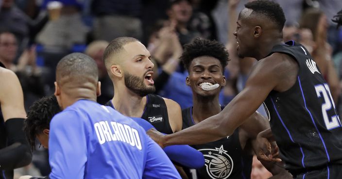 Orlando Magic guard Evan Fournier, second from left, celebrates with teammates, from left, Isaiah Briscoe, Fournier, Jonathan Isaac and Jerian Grant, after making the winning basket at the buzzer to defeat the Detroit Pistons in an NBA basketball game, Sunday, Dec. 30, 2018, in Orlando, Fla. (AP Photo/John Raoux)