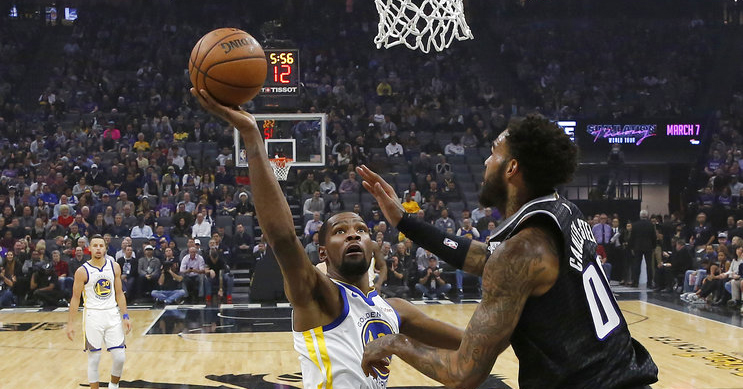 Golden State Warriors forward Kevin Durant, left, goes up to shoot against Sacramento Kings center Willie Cauley-Stein during the first half of an NBA basketball game Friday, Dec. 14, 2018, in Sacramento, Calif. (AP Photo/Rich Pedroncelli)