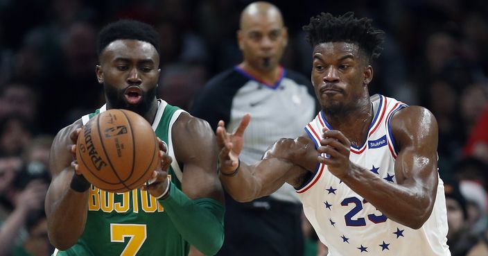 Boston Celtics' Jaylen Brown (7) drives past Philadelphia 76ers' Jimmy Butler (23) during the second half of an NBA basketball game in Boston, Tuesday, Dec. 25, 2018. (AP Photo/Michael Dwyer)