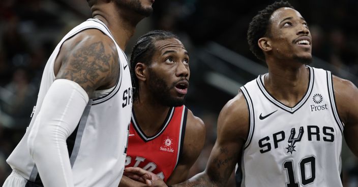 Toronto Raptors forward Kawhi Leonard (2) and San Antonio Spurs guard DeMar DeRozan (10) jockey for a rebound during the first half of an NBA basketball game, Thursday, Jan. 3, 2019, in San Antonio. (AP Photo/Eric Gay)