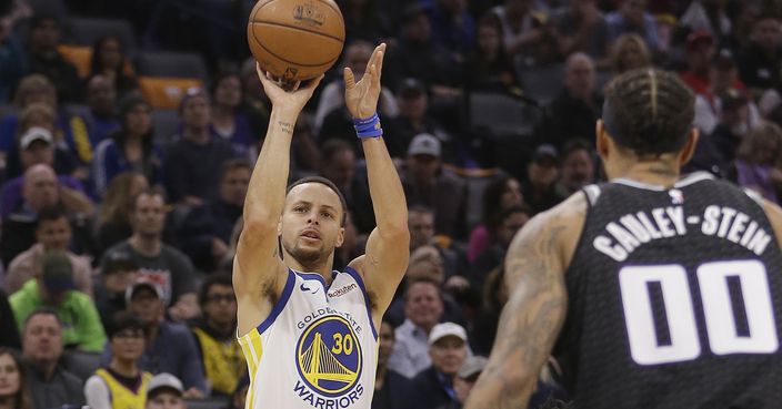 Golden State Warriors guard Stephen Curry, left, shoots as Sacramento Kings center Willie Cauley-Stein, right, looks on during the first quarter of an NBA basketball game, Saturday, Jan. 5, 2019, in Sacramento, Calif. The Warriors won 127-123. (AP Photo/Rich Pedroncelli)