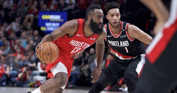Houston Rockets guard James Harden, left, dribbles past Portland Trail Blazers guard Evan Turner during the first half of an NBA basketball game in Portland, Ore., Saturday, Jan. 5, 2019. (AP Photo/Craig Mitchelldyer)