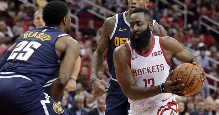 Houston Rockets guard James Harden (13) drives to the basket between Denver Nuggets guard Malik Beasley (25) and forward Torrey Craig, back, during the second half of an NBA basketball game Monday, Jan. 7, 2019, in Houston. (AP Photo/Michael Wyke)
