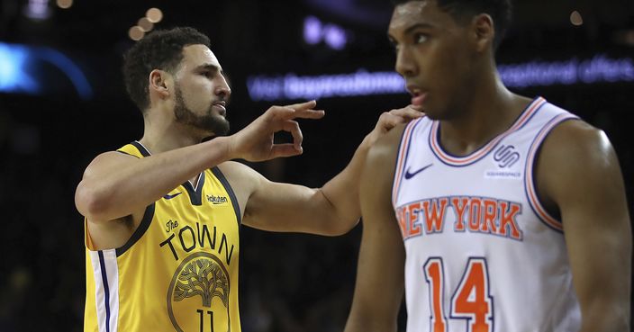 Golden State Warriors' Klay Thompson, left, celebrates a score, next to New York Knicks' Allonzo Trier (14) during the second half of an NBA basketball game Tuesday, Jan. 8, 2019, in Oakland, Calif. (AP Photo/Ben Margot)