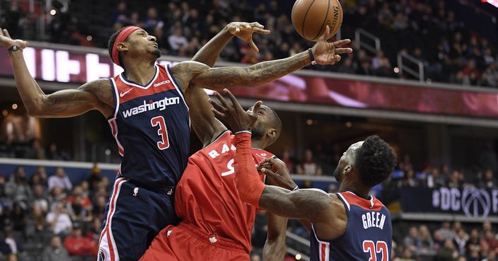 Washington Wizards guard Bradley Beal (3) and forward Jeff Green (32) battle for the rebound against Toronto Raptors forward Serge Ibaka (9) during the first half of an NBA basketball game, Sunday, Jan. 13, 2019, in Washington. (AP Photo/Nick Wass)