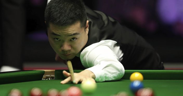 China's Ding Junhui plays a shot during a match against Belgium's Luca Brecel, during day five of the 2019 Snooker Masters at Alexandra Palace, in London, Thursday, Jan. 17, 2019. (Adam Davy/PA via AP)