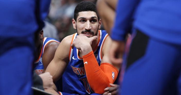 FILE - In this Jan. 1, 2019, file photo, New York Knicks centre Enes Kanter, of Turkey, jokes with teammates during a timeout the first half of the team's NBA basketball game against the Denver Nuggets, in Denver.  Turkish media reports said Wednesday, Jan. 16, 2019, that Turkish prosecutors are seeking an international arrest warrant and had prepared an extradition request for Kanter, accusing him of membership in a terror organisation. Sabah newspaper said prosecutors were seeking an Interpol 