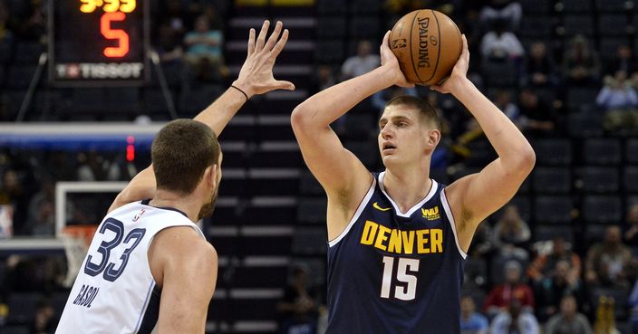 Denver Nuggets center Nikola Jokic (15) handles the ball against Memphis Grizzlies center Marc Gasol (33) in the first half of an NBA basketball game Monday, Jan. 28, 2019, in Memphis, Tenn. (AP Photo/Brandon Dill)