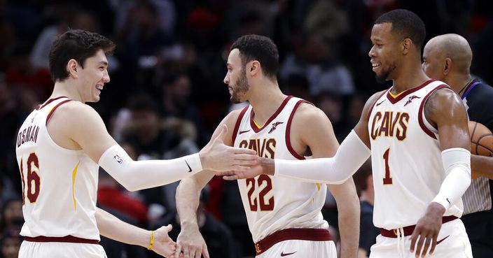 Cleveland Cavaliers forward Cedi Osman, left, celebrates with forward Larry Nance Jr., center, and forward Rodney Hood after the Cleveland defeated the Chicago Bulls 104-101 in an NBA basketball game Sunday, Jan. 27, 2019, in Chicago. (AP Photo/Nam Y. Huh)