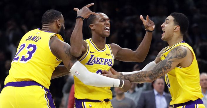 Los Angeles Lakers guard Rajon Rondo, middle, celebrates his game-winning shot with teammates LeBron James (23) and Kyle Kuzma (0), in an NBA basketball game against the Boston Celtics, Thursday, Feb. 7, 2019, in Boston. The Lakers won 129-128. (AP Photo/Elise Amendola)