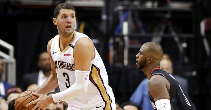 FILE - In this  Wednesday, Oct. 17, 2018 file photo, New Orleans Pelicans forward Nikola Mirotic (3) looks to pass the ball over Houston Rockets guard Chris Paul (3) during the second half of an NBA basketball game in Houston. Toronto, Milwaukee and Philadelphia made their moves. Anthony Davis will have to wait until the summer for his. The New Orleans Pelicans held onto Davis but dealt Nikola Mirotic to the Bucks, one of the Eastern Conference contenders who fortified their teams on Thursday, Feb. 7, 2019 before the NBA trade deadline. The Raptors are getting center former All-Star center Marc Gasol from Memphis.(AP Photo/Michael Wyke, File)