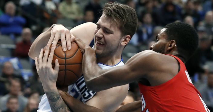 Dallas Mavericks forward Luka Doncic (77) and Portland Trail Blazers forward Maurice Harkless (4) wrestle for control of the ball in the first half of an NBA basketball game in Dallas, Sunday, Feb. 10, 2019. (AP Photo/Tony Gutierrez)
