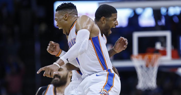 Oklahoma City Thunder guard Russell Westbrook, left, and forward Paul George, right, celebrate late in the second half of an NBA basketball game against the Portland Trail Blazers in Oklahoma City, Monday, Feb. 11, 2019. (AP Photo/Sue Ogrocki)