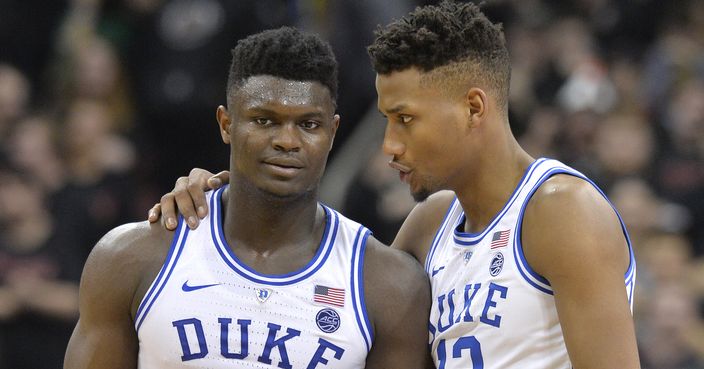 Duke forward Zion Williamson (1) talks with forward Javin DeLaurier (12) during the second half of the team's NCAA college basketball game against Louisville in Louisville, Ky., Tuesday, Feb. 12, 2019. Duke won 71-69. (AP Photo/Timothy D. Easley)