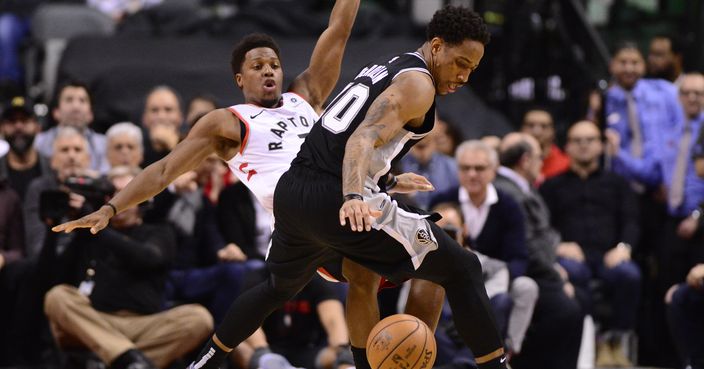 Toronto Raptors guard Kyle Lowry falls after he and San Antonio Spurs guard DeMar DeRozan (10) collided during the second half of an NBA basketball game Friday, Feb. 22, 2019, in Toronto. (Frank Gunn/The Canadian Press via AP)