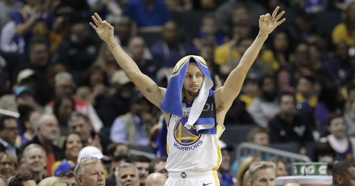 Golden State Warriors' Stephen Curry gestures from the bench after a teammate's basket against the Charlotte Hornets during the first half of an NBA basketball game in Charlotte, N.C., Monday, Feb. 25, 2019. (AP Photo/Chuck Burton)