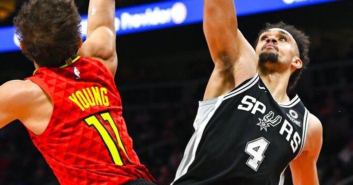 San Antonio Spurs guard Derrick White (4) blocks the shot of Atlanta Hawks guard Trae Young during the second half of an NBA basketball game, Wednesday, March 6, 2019, in Atlanta. San Antonio won 111-104. (AP Photo/John Amis)