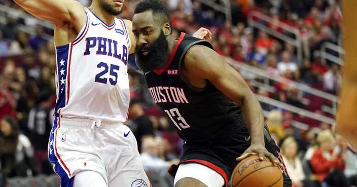 Houston Rockets' James Harden (13) drives toward the basket as Philadelphia 76ers' Ben Simmons (25) defends during the second half of an NBA basketball game Friday, March 8, 2019, in Houston. (AP Photo/David J. Phillip)