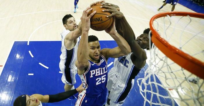 Philadelphia 76ers' Ben Simmons (25) tries to get a shot past Orlando Magic's Jonathan Isaac, from right, Nikola Vucevic and Aaron Gordon during the first half of an NBA basketball game, Tuesday, March 5, 2019, in Philadelphia. (AP Photo/Matt Slocum)