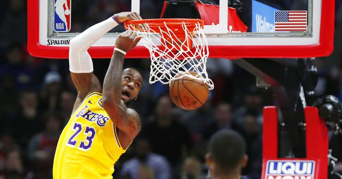 Los Angeles Lakers forward LeBron James (23) dunks in front of Chicago Bulls guard Kris Dunn during the second half of an NBA basketball game Tuesday, March 12, 2019, in Chicago. (AP Photo/Nuccio DiNuzzo)