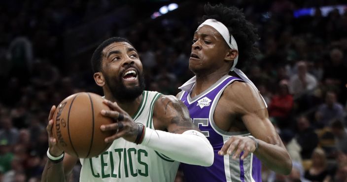 Boston Celtics guard Kyrie Irving (11) drives against Sacramento Kings guard De'Aaron Fox in the first half of an NBA basketball game, Thursday, March 14, 2019, in Boston. (AP Photo/Elise Amendola)