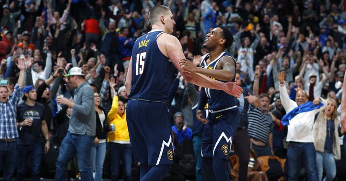 Denver Nuggets center Nikola Jokic, left, is congratulated for his game-winning basket by guard Monte Morris during the team's NBA basketball game against the Dallas Mavericks on Thursday, March 14, 2019, in Denver. The Nuggets won 100-99. (AP Photo/David Zalubowski)