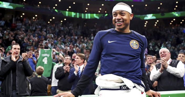 Denver Nuggets guard Isaiah Thomas smiles as his acknowledged by fans during a video tribute during a break the first quarter of an NBA basketball game against the Boston Celtics in Boston, Monday, March 18, 2019. Thomas returned to play in his first game after being traded in 2017 for Kyrie Irving. (AP Photo/Charles Krupa)