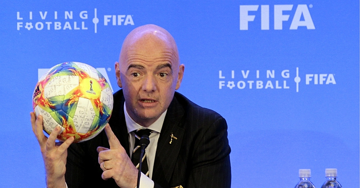 FIFA President Gianni Infantino holds a soccer ball as he speaks during a press conference after the FIFA Council Meeting, Friday, March 15, 2019, in Miami. (AP Photo/Luis M. Alvarez)