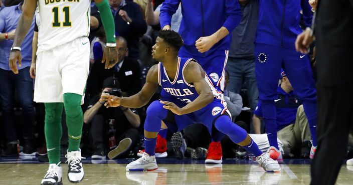 Philadelphia 76ers' Jimmy Butler, center, celebrates after scoring a basket against Boston Celtics' Kyrie Irving during the second half of an NBA basketball game Wednesday, March 20, 2019, in Philadelphia. Philadelphia won 118-115. (AP Photo/Matt Slocum)