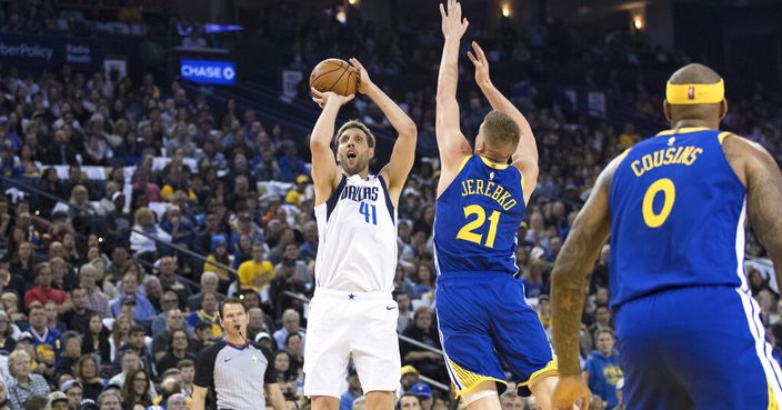 Dallas Mavericks forward Dirk Nowitzki (41) shoots as Golden State Warriors forward Jonas Jerebko (21) defends in the first half of an NBA basketball game Saturday, March 23, 2019, in Oakland, Calif. (AP Photo/John Hefti)