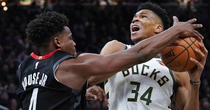 Milwaukee Bucks' Giannis Antetokounmpo is fouled by Houston Rockets' Danuel House Jr. during the second half of an NBA basketball game Tuesday, March 26, 2019, in Milwaukee. The Bucks won 108-94. (AP Photo/Morry Gash)