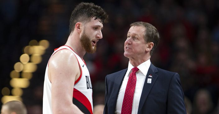 Portland Trail Blazers center Jusuf Nurkic, left, talks with Portland Trail Blazers head coach Terry Stotts as the Blazers beat the Brooklyn Nets in double overtime, 148-144, during an NBA basketball game in Portland, Ore., Monday, March 25, 2019. (AP Photo/Randy L. Rasmussen)