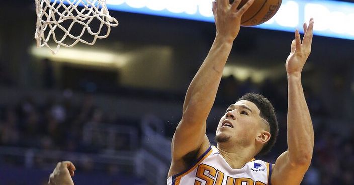 Phoenix Suns guard Devin Booker (1) gets a shot off and is fouled by Washington Wizards forward Jeff Green, left, during the first half of an NBA basketball game Wednesday, March 27, 2019, in Phoenix. (AP Photo/Ross D. Franklin)