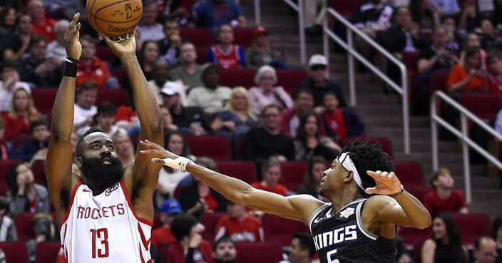 Houston Rockets guard James Harden (13) shoots a three-point basket as Sacramento Kings guard De'Aaron Fox defends during the second half of an NBA basketball game, Saturday, March 30, 2019, in Houston. (AP Photo/Eric Christian Smith)